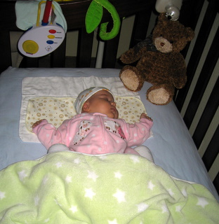 Ari sleeping in her crib
